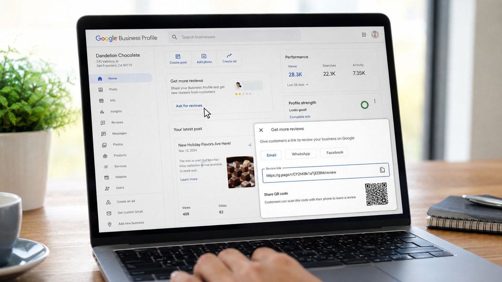 A person using a laptop to open a Google Business Profile menu to share a review link.