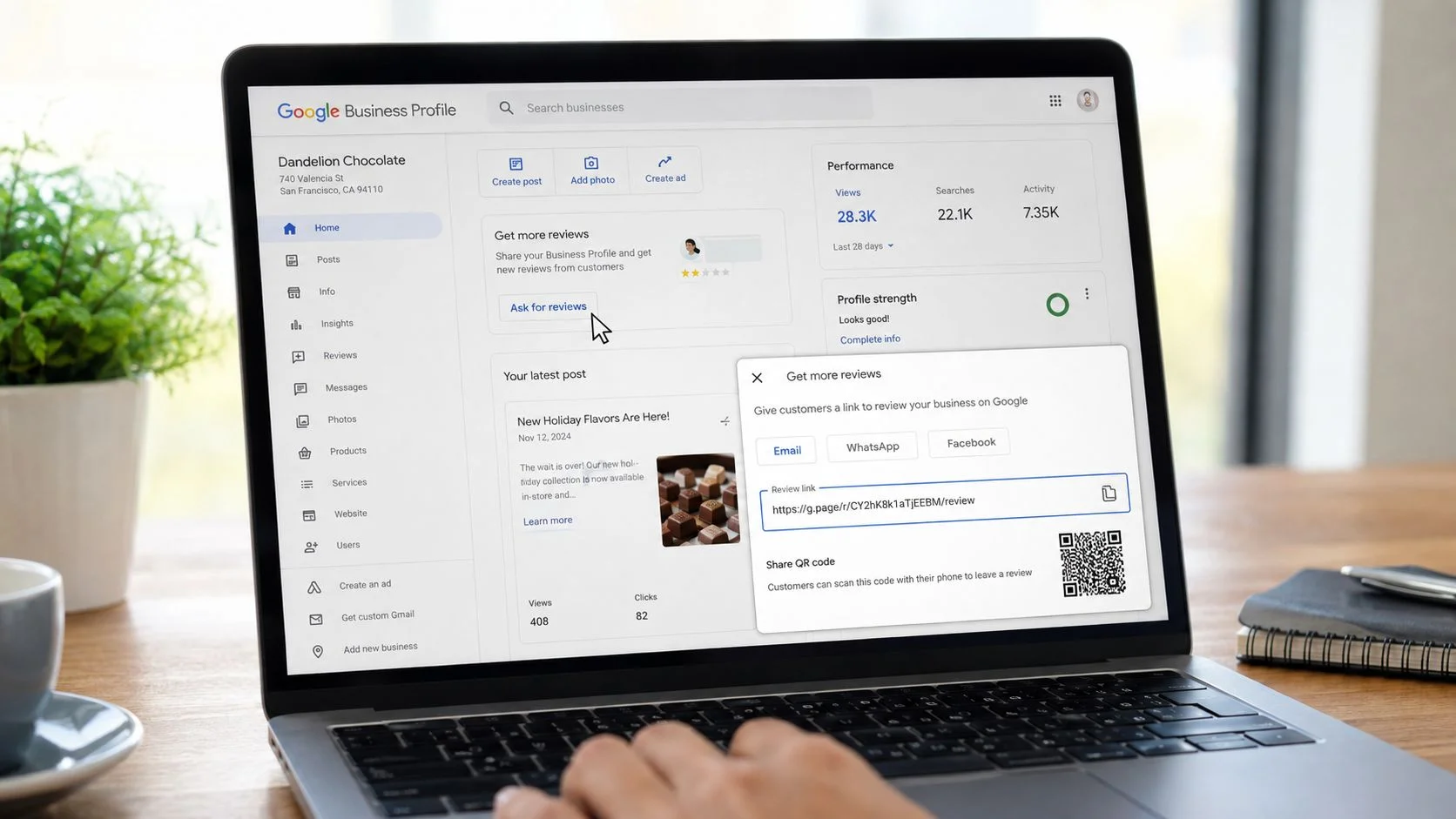 A person using a laptop to open a Google Business Profile menu to share a review link.